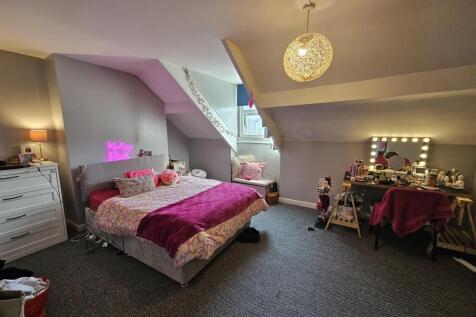 A spacious and cozy master bedroom featuring a ...