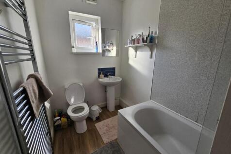 A bright and well-maintained bathroom featuring...