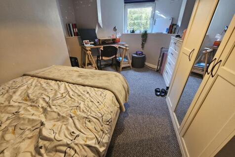 Cozy single bedroom with a window providing nat...