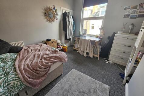 Cozy single bedroom featuring a comfortable bed...