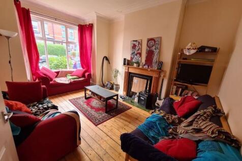 A cozy and inviting living room featuring natur...