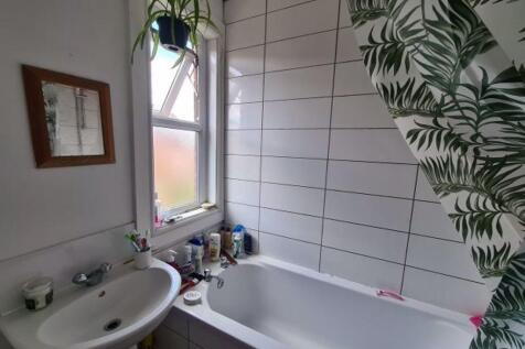 Bright and modern bathroom featuring a large ba...