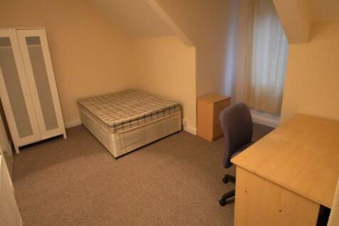 A clean and tidy single bedroom featuring a com...