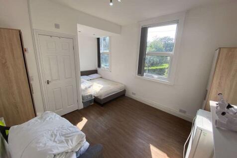 Bright and airy bedroom featuring large windows...