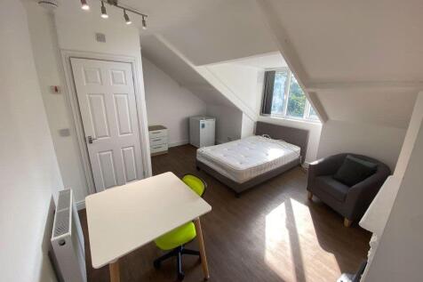 A bright and tidy bedroom featuring a double be...