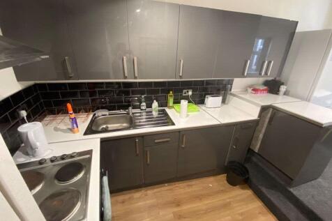 A modern, well-organized kitchen with sleek gra...