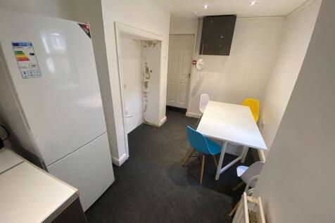 A bright and tidy kitchen area with modern appl...