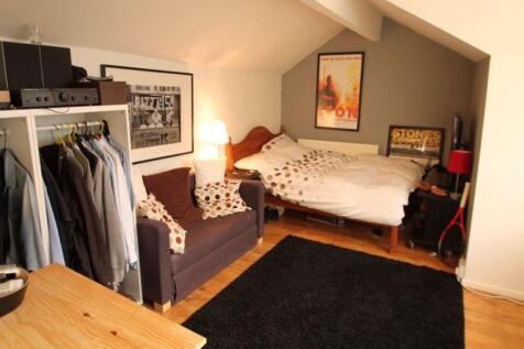 A spacious and well-lit master bedroom featurin...