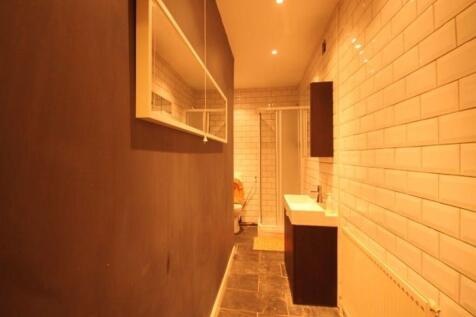 A well-maintained bathroom featuring a clean, m...