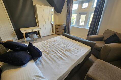 A spacious and inviting master bedroom featurin...