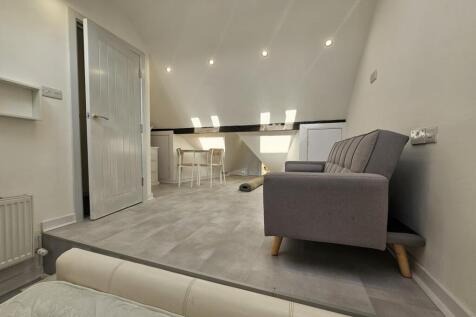 A spacious and modern living room featuring com...