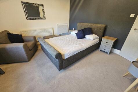 A bright and inviting living room featuring com...