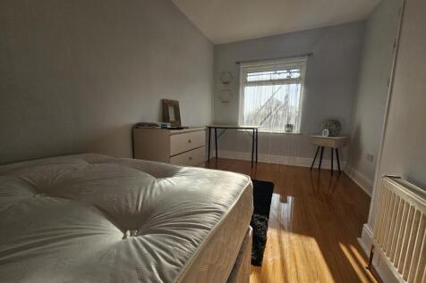 Bright and inviting bedroom featuring a large b...