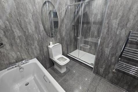 Modern and clean bathroom with a spacious showe...