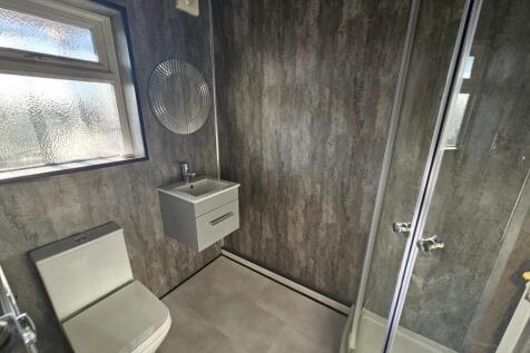A spacious and modern bathroom featuring a larg...