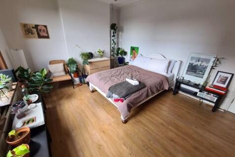 Bright and spacious master bedroom featuring a ...