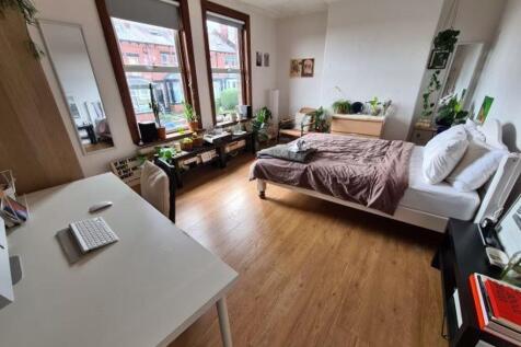 A bright and spacious living room with large wi...