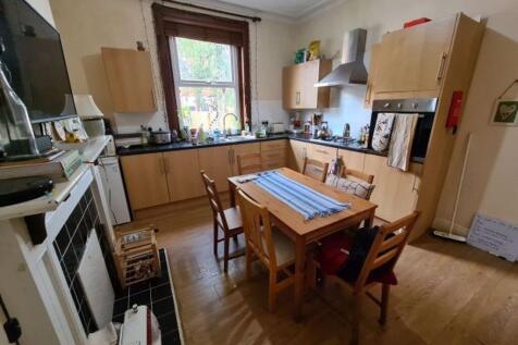 A well-lit, clean kitchen with ample counter sp...