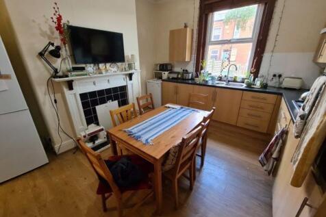 A bright and cozy kitchen with natural light co...