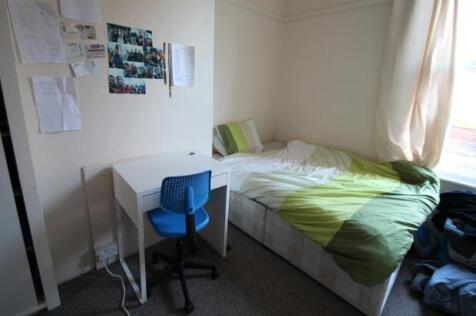 A spacious double bedroom featuring a double be...