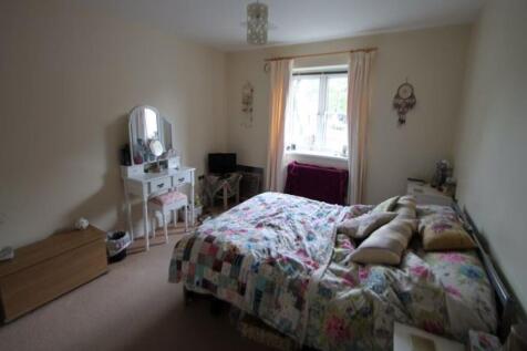 A spacious and cozy master bedroom filled with ...