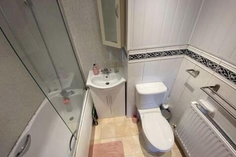 A clean, well-maintained bathroom featuring a t...