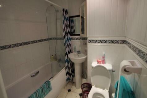 A spacious, well-maintained bathroom with a bat...