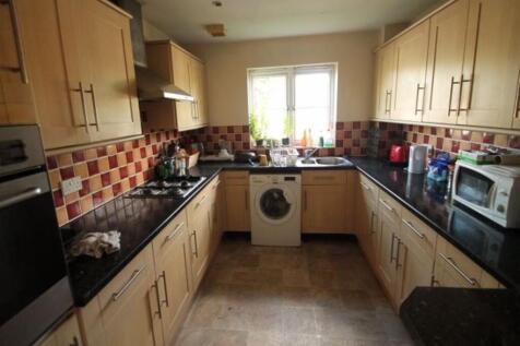 A well-lit kitchen area with ample counter spac...