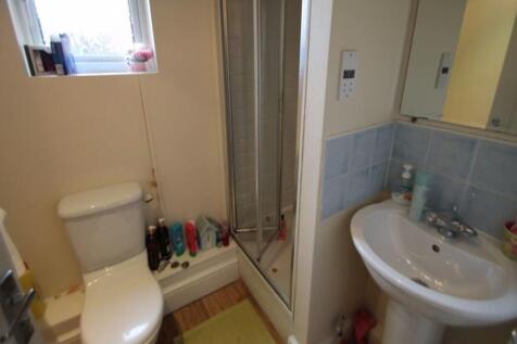 A clean and modern bathroom featuring a toilet,...