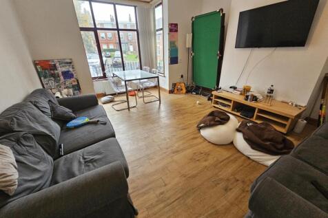 A spacious, well-lit modern living room featuri...