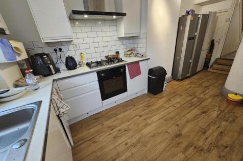 Bright and modern kitchen featuring ample count...