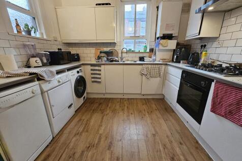 Bright, modern kitchen with plenty of storage a...