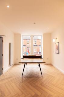 Bright and welcoming living room featuring larg...