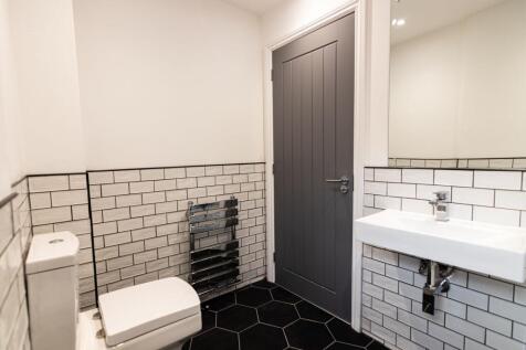 Modern and tidy bathroom featuring a sleek toil...