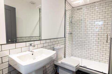 Modern bathroom featuring a sleek white basin, ...