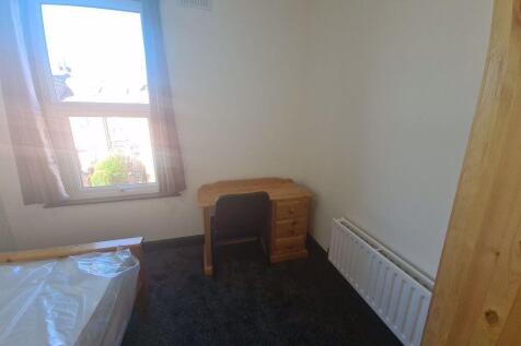 A cozy bedroom featuring a window that allows n...