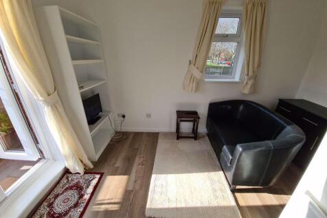 A bright and tidy living room featuring natural...