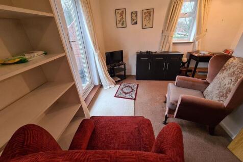 A cozy living room featuring comfortable armcha...