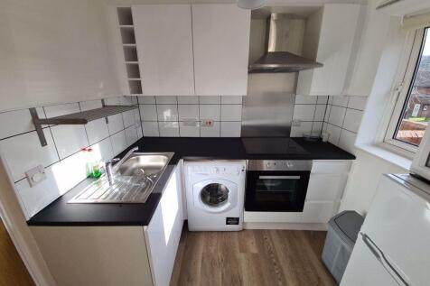 Bright and modern kitchen featuring sleek black...