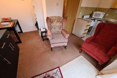 A cozy living room featuring comfortable armcha...