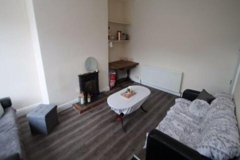 A cozy and well-maintained living room featurin...