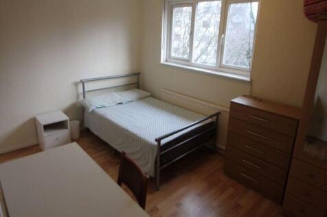 A cozy student bedroom with a clean, simple set...