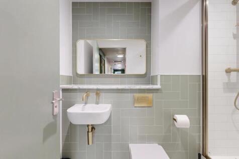 Contemporary bathroom with pale green wall tile...