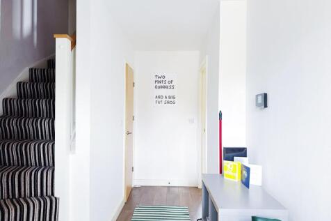 A bright and tidy entrance area with a striped ...