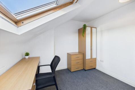 A bright, well-maintained bedroom featuring a s...