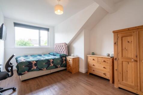 Bright and welcoming bedroom featuring a comfor...