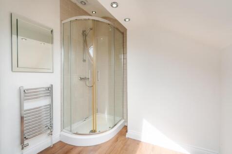 Bright and modern bathroom featuring a spacious...