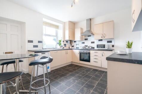 Bright and modern kitchen with ample natural li...