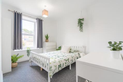 Bright and inviting bedroom featuring a fresh, ...