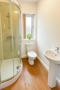 Bright and clean bathroom featuring a modern cu...